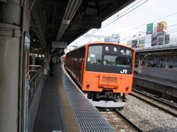 A Chuo Line elevated train pulling into a Japan Railways (JR) station near the center of Tokyo.